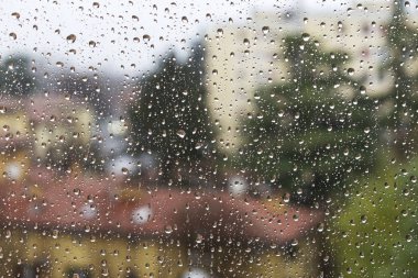 Raindrops on glass in rainy weather. Winter mood