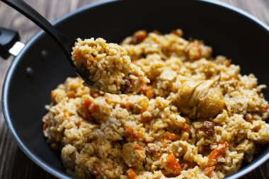 Geleneksel ev yapımı Özbek pilavı veya demir tavada plov. Özbek mutfağı. Yakın çekim. Seçici Odaklanma.