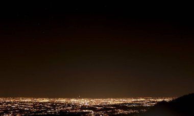 Night panorama overlooking the city of Como from the Palanzone mountain in Lombardy