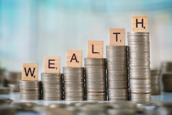 Stack of Coins with Wooden Scrabble Letters — Stock Photo, Image