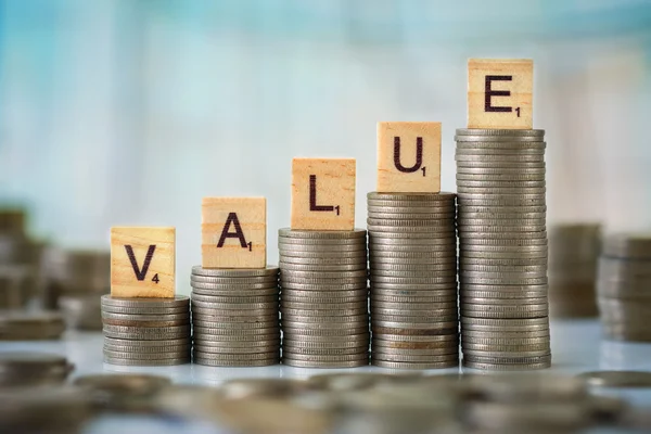 Stck of Coins with Wooden Letters — Stockfoto