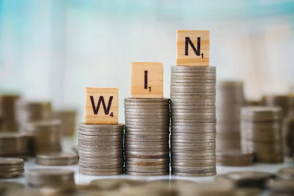 Stack of Coins with Wooden Letters — Stock Photo, Image