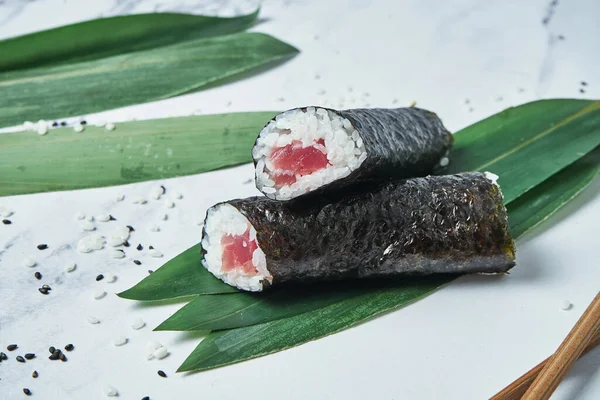 Fresh rolls with fresh tuna, rice and norms on a white background. Japanese traditional sushi rolls. Close up, selective focus