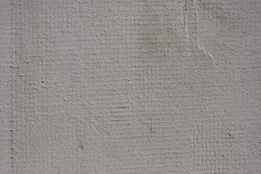 Sıvalı boyanmamış bir duvarın dokusu ve düzgün bir ağ. İnşaat ve onarım teması için uygun arkaplan.