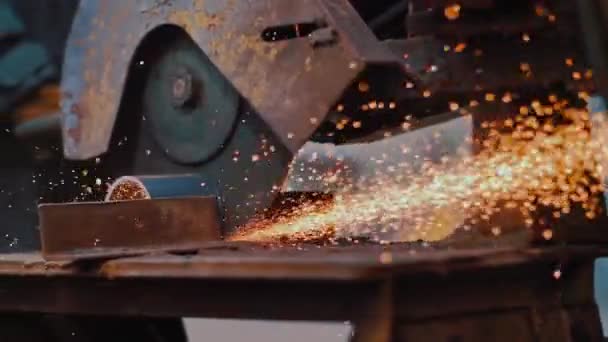 Industrial worker grinding metal with a lot of sharp. Sparks close-up of sawing a pipe with a rusty circular machine. Grunge texture. Sparks in slow motion 200 fps — Stock Video