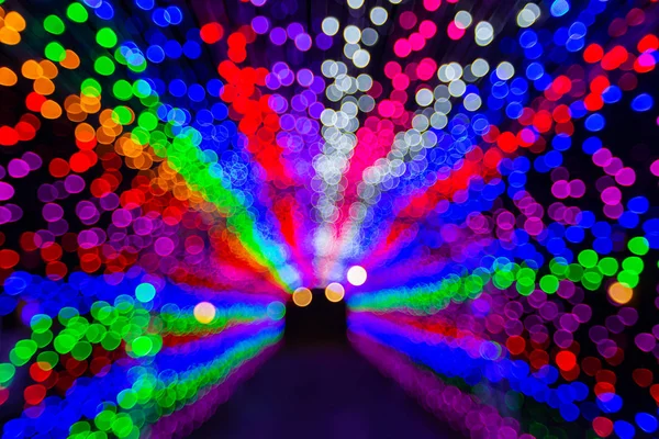 Blurry LED light tunnel on night for background.