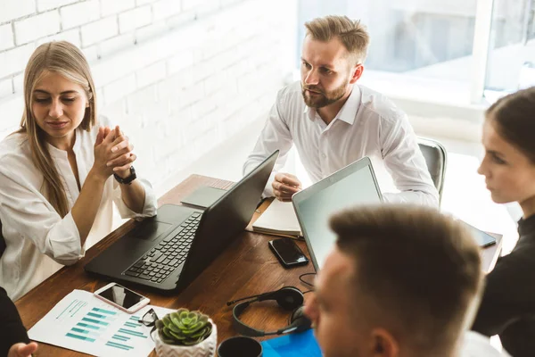 Un equipo de jóvenes empresarios que trabajan y se comunican en una oficina. Corporativossteam y gerente en una reunión. — Foto de Stock