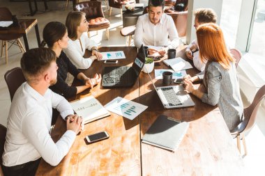 Ofiste birlikte çalışan ve iletişim kuran genç iş adamlarından oluşan bir ekip. Şirket buharı ve bir toplantıda yönetici..