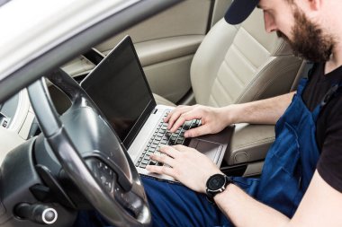 Araba tamiri servisinde çalışan profesyonel bir tamirci. Bilgisayar video araştırması. Motor kontrolleri. Servis İstasyonu.