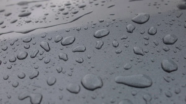 Real hydrophobic effect in the rain on a car body (Daytona grey pearl effect) treated with wax
