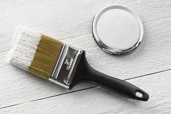 Paintbrush and white paint