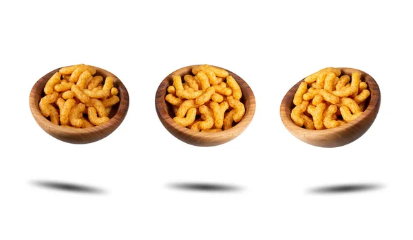 Puffed peanuts snacks in wooden bowls. Isolated.