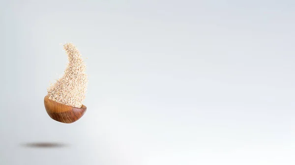 Açık gri arka planda uçan yulaf lapaları.