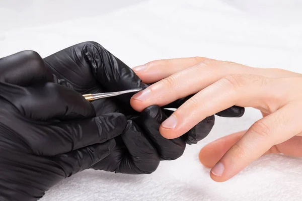 Manicura en guantes negros haciendo manicura mans. — Foto de Stock