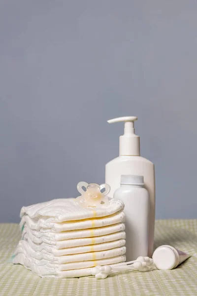 Newborn baby care supplies on changing table.