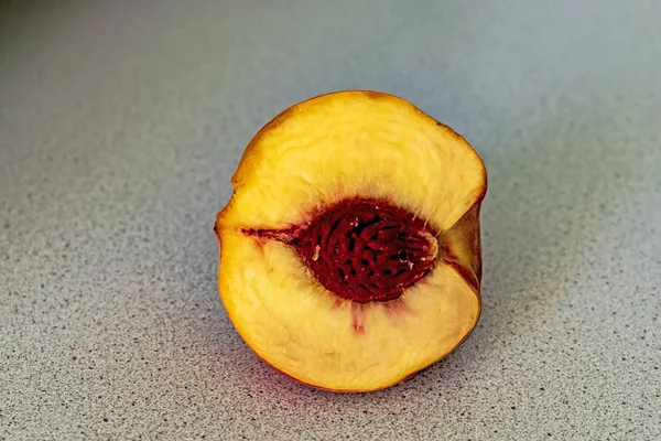 A half of peach on the wooden table