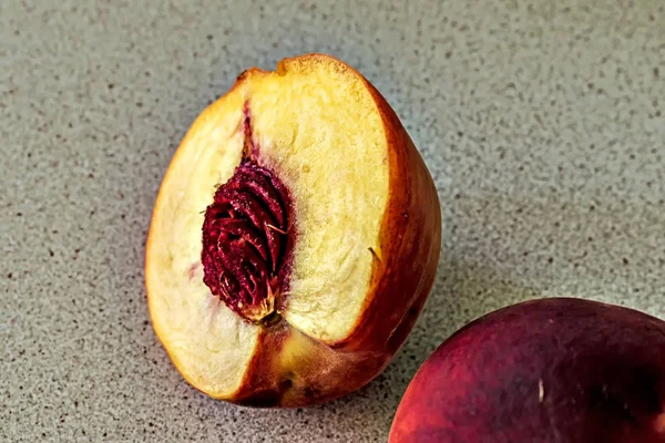 A half of peach on the wooden table