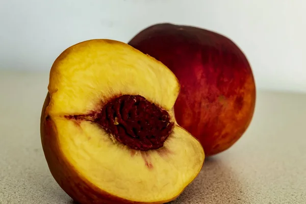 A half of peach on the wooden table