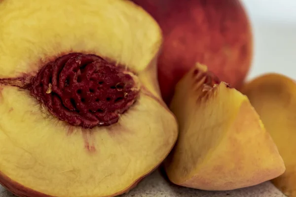 A half of peach on the wooden table