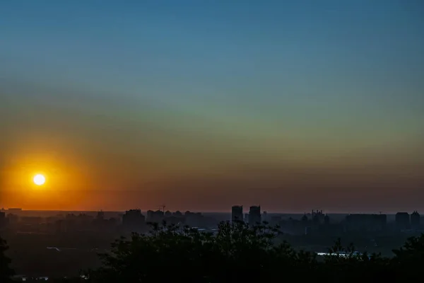 The rising sun above the city