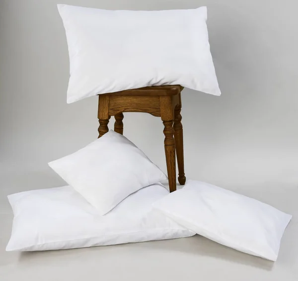 Composition of white pillows, isolated, on a gray background. — Stock Photo, Image