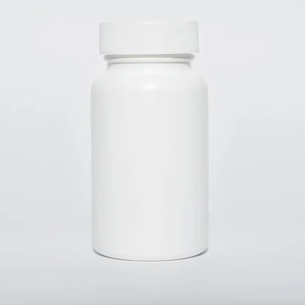 Small white vial with lid, isolated, close-up. — Stock Photo, Image