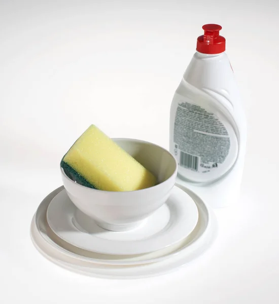 Dish detergent, plates and sponge, on white background — Stock Photo, Image