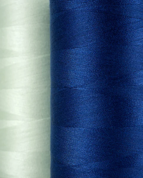 Spool of blue and green thread — 스톡 사진