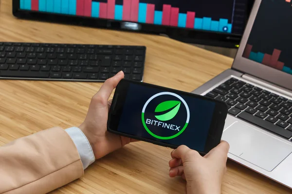 SAN FRANCISCO, US - 18.10.2019: Female Trader Hands Holding the Smartphone Using Application of Bitfinex Cryptocurrency Exchange Market. Cryptocurrency Background Concept, San Francisco, California, U — Stock Photo, Image