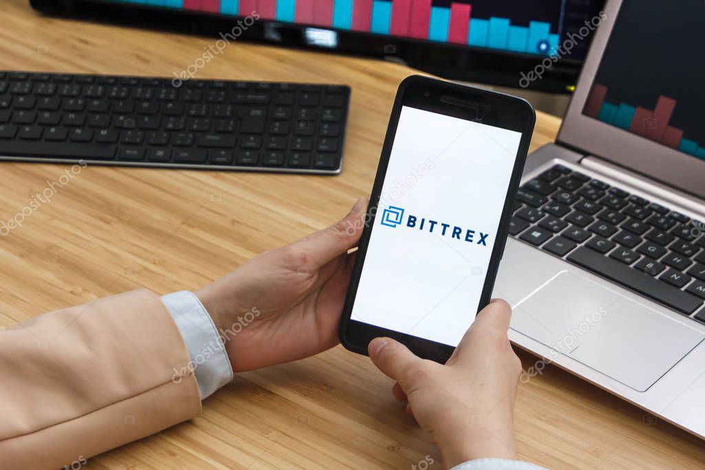 Bittrex Cryptocurrency Exchange Market. Female Trader Hands Holding the Smartphone Using Application. Crypto Background Concept, San Francisco, California, USA - 18.10.2019. An Illustrative Editorial Image.