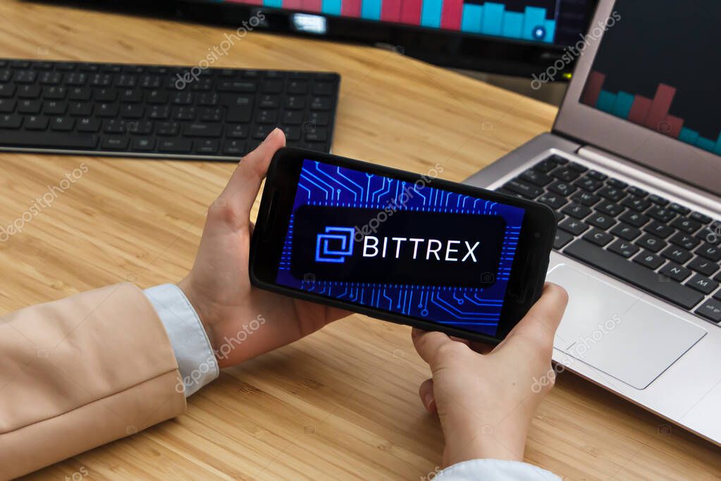 Bittrex Cryptocurrency Exchange Market. Female Trader Hands Holding the Smartphone Using Application. Crypto Background Concept, San Francisco, California, USA - 18.10.2019. An Illustrative Editorial Image.