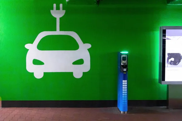 Symbol sign of electric cars charging station. Plug-in charger or socket for PHEV cars or vehicles. Concept of green electricity, clean environment, emission reduction.