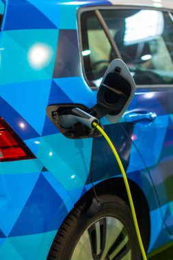 Elektrik ya da hibrit bir Phev 'e elektrik kablosu takılı olarak şarj ediliyor. Elektrikli araba şarj istasyonu