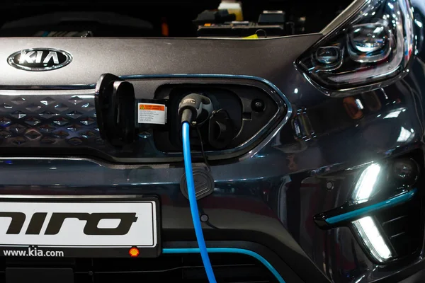 Charging an plug-in hybrid Kia Niro with the power cable supply plugged in, Prague, Czechia, November 2019. — Stock Photo, Image