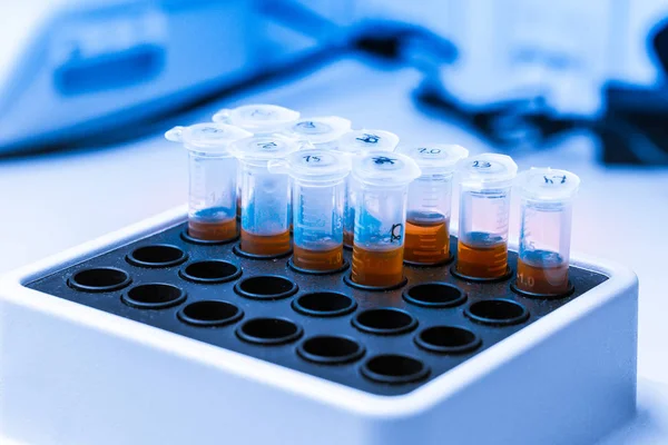 Orange substance in microtube is put in thermo shaker. DNA experiment in biochemical laboratory. Clinical concept illustration. Synthesis of new vaccine or medicine against coronavirus — 스톡 사진