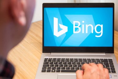 Bing is used by a man on the laptop. Microsoft customer used computer software. New product is tested by IT specialist. San Francisco, February 2020.