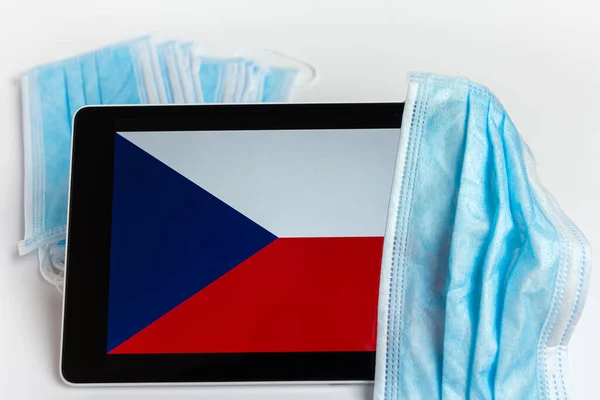 Czech Republic flag covered by surgical protective mask for coronavirus COVID-19 prevention
