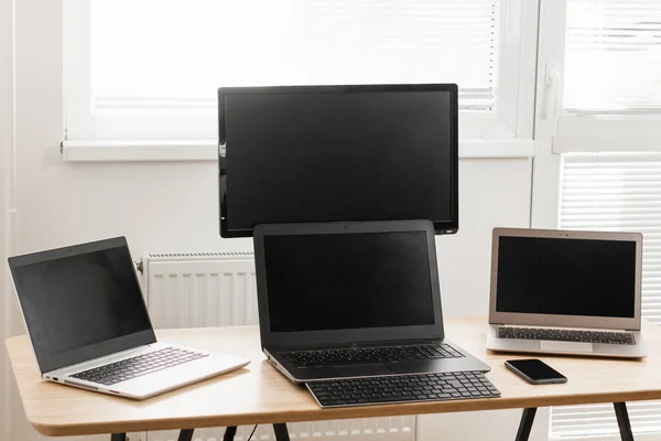 Three computers are on the desk. Home office concept. Video makers work place.