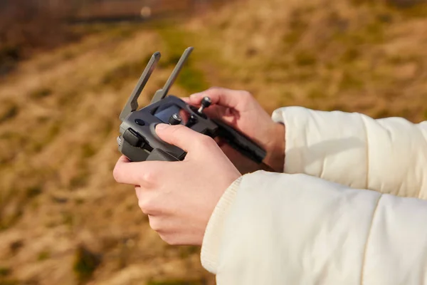 Cierra las manos de las mujeres sosteniendo un mando a distancia de un dron. Grabando video en el aire. Concepto de vuelo Quadrocopter . —  Fotos de Stock
