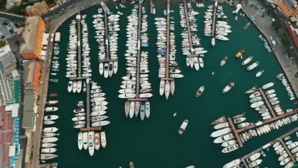 Flying above a harbor with yachts, boats and opening of town panorama with traditional colorful italian houses on mountains background. — Stock Video