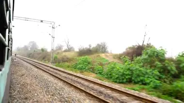 Hint Demiryolları. Yolcu treni, demiryolu ile. Rayları değiştirirken son arabanın camından vurulmuş. Hint tren yolu, Hindistan.