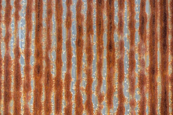 Detail of old rusty metal plate painted in red color. Metal texture background.