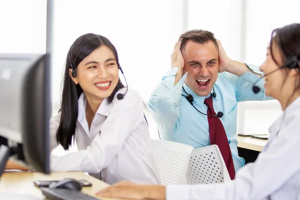 Harmful noisy environment in the workplace issue. A man screaming to his colleague who enjoy talking louder in the office. Stress and problem in workplace with co-worker and other employees concept.
