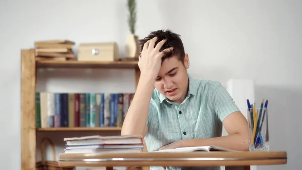 Upset schoolboy doing homework — Stock Photo, Image