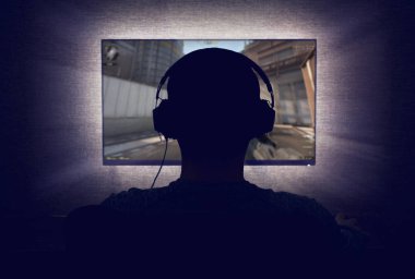 Gamer in front of a blank monitor clipart