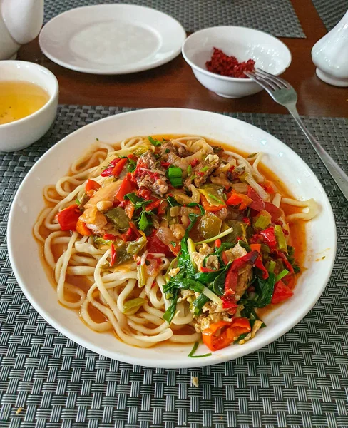 Uzbeko tradizionale lagman cibo nazionale, zuppa con tagliatelle, verdure e carne — Foto Stock