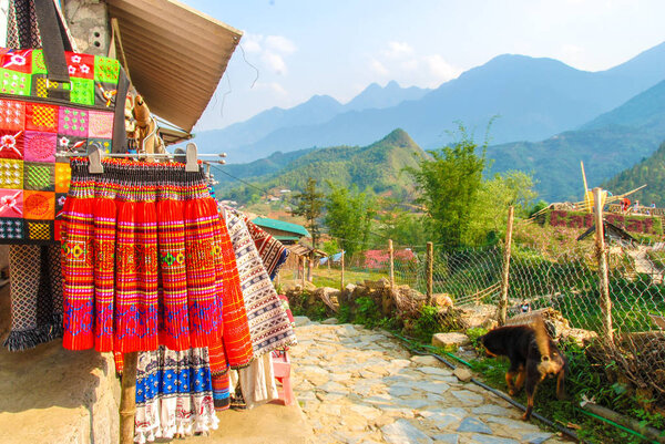 Street in Cat Cat Hmong village by Sapa with market full of traditional colorful clothes, Vietnam