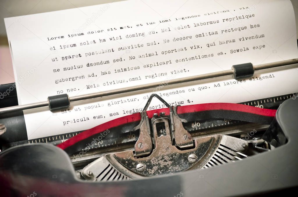Close Up of Antique Typewriter with Ribbon Typing Lorem Ipsum