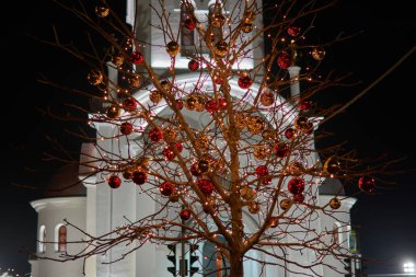 Christmas balls on a tree in front of the church