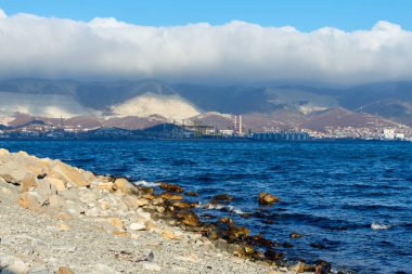 Sea shore and clouds over the mountains